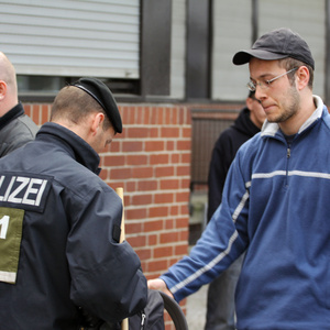 Sebastian Thom, NPD-Kreisverbandschef von Neukölln wird bei einer NPD Kundgebung 2011 in Berlin von der Polizei durchsucht.