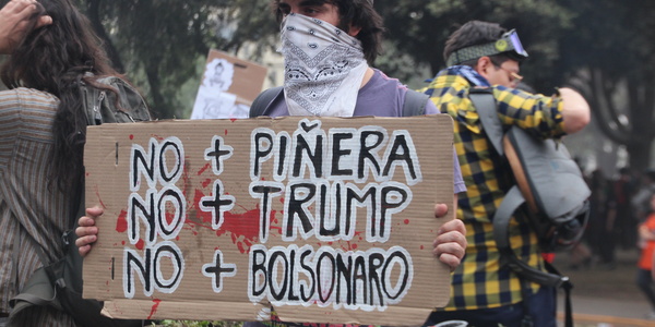 Protestschild gegen Pinera, Trump und Bolsonaro